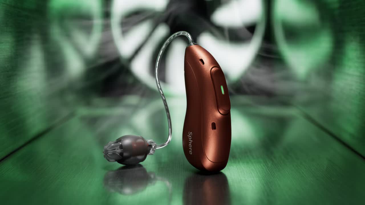 A Phonak Eon receiver-in-canal hearing aid in a copper finish, shown in front of wind tunnel fans to illustrate its wind and motion handling