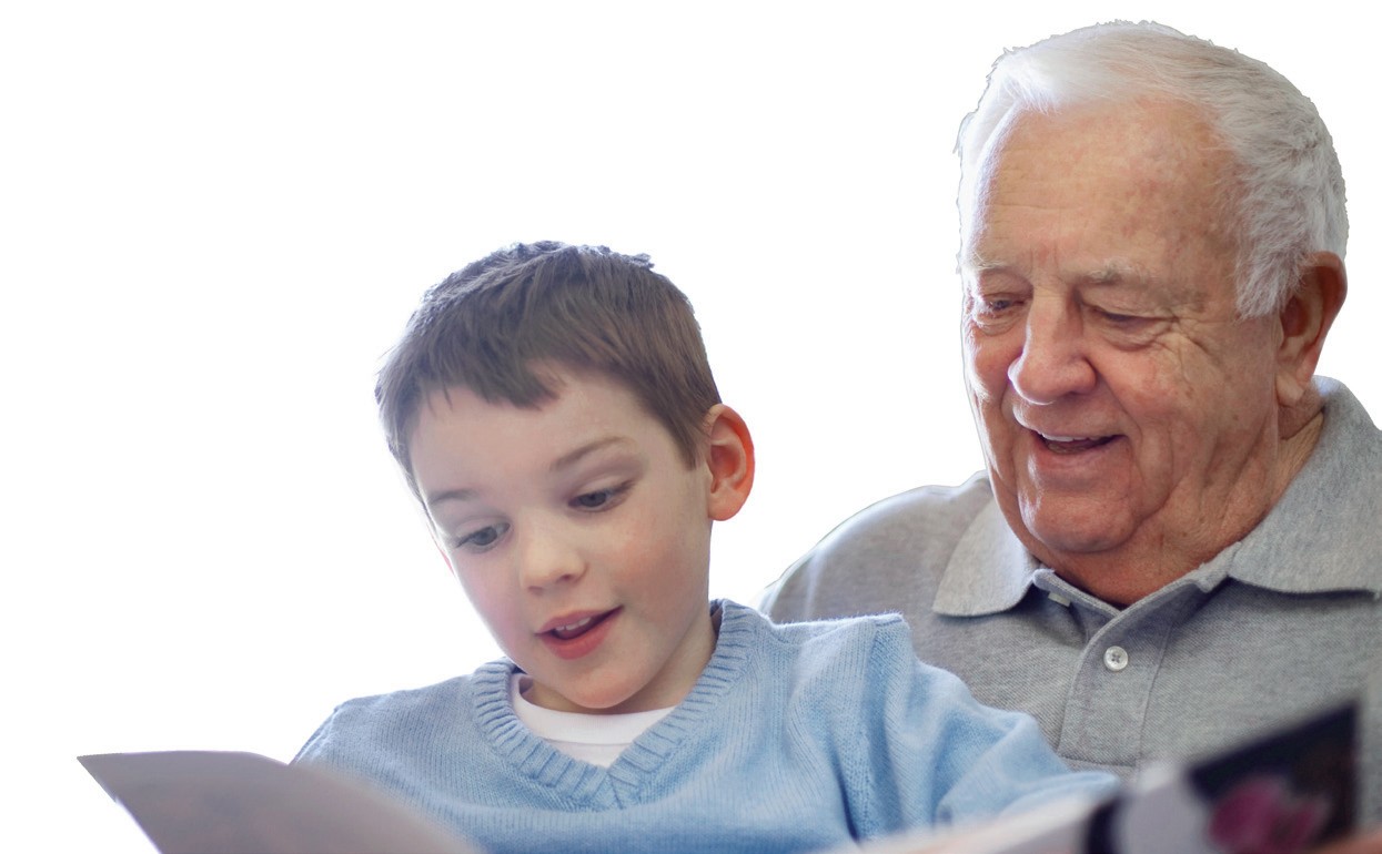 A grandfather and young child sharing a book together